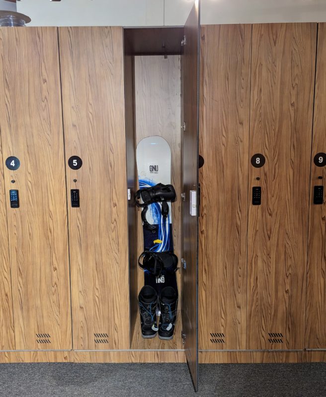 A Large Ski Locker hourly with skis and snowboards in it.