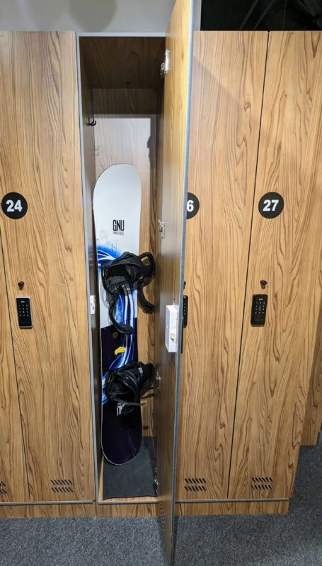 A Small Ski locker - daily containing a snowboard.