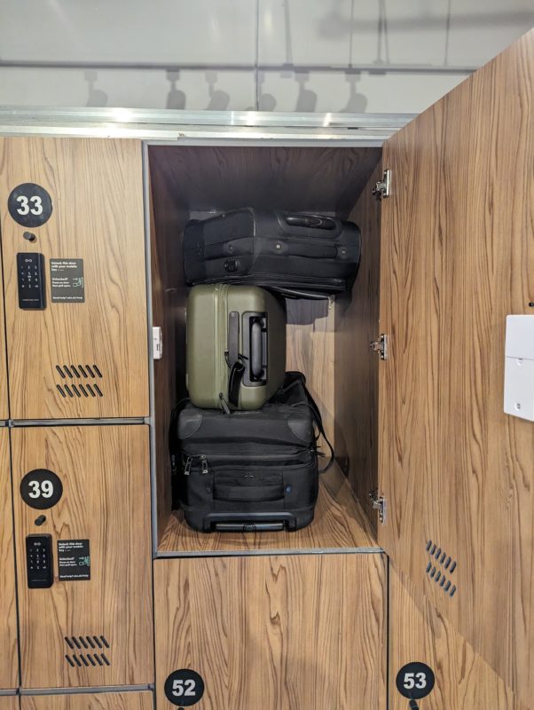 About Us: A locker filled with several suitcases.