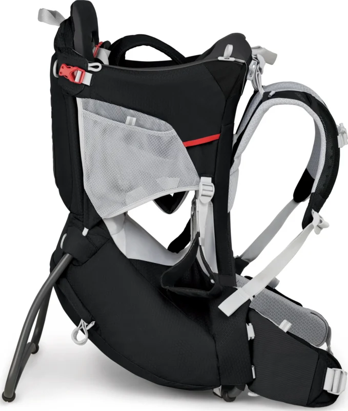 The Loaded Locker - Osprey Baby Hiking Carrier is a black baby carrier designed for hiking, featuring a red buckle, white straps, and a mesh pocket on the side. It boasts a sturdy frame and an adjustable seat.